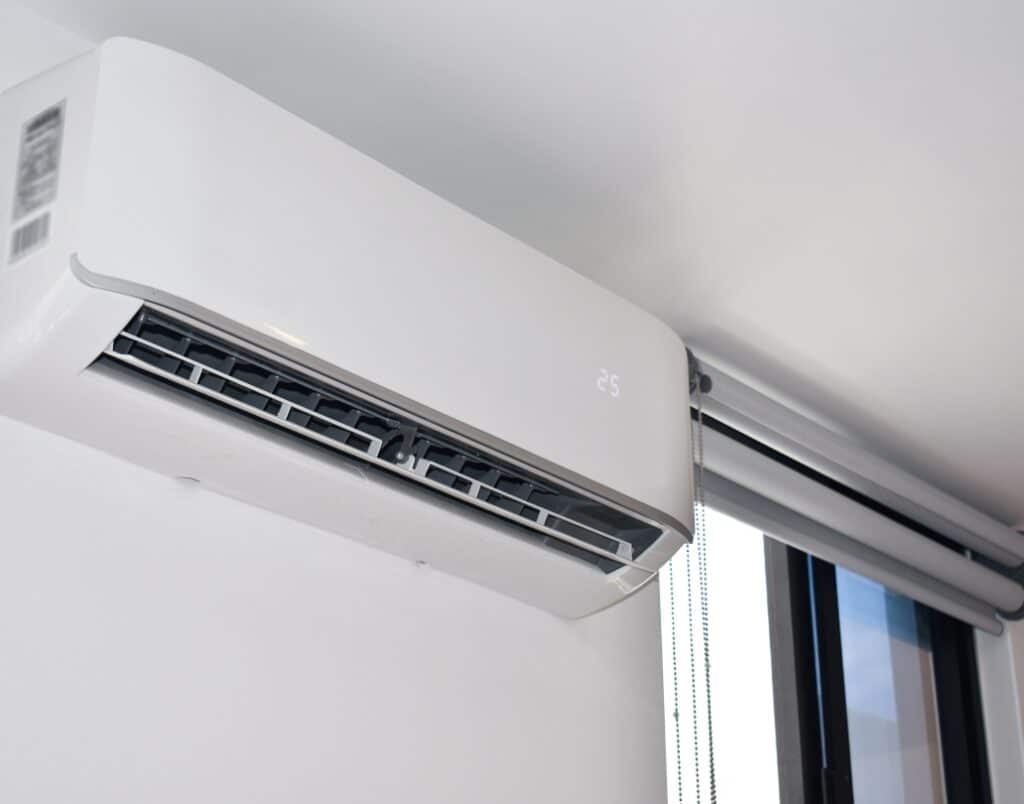  A wall-mounted HVAC unit in a bedroom, providing energy-efficient heating and ventilation, essential for year-round comfort in an ADU.