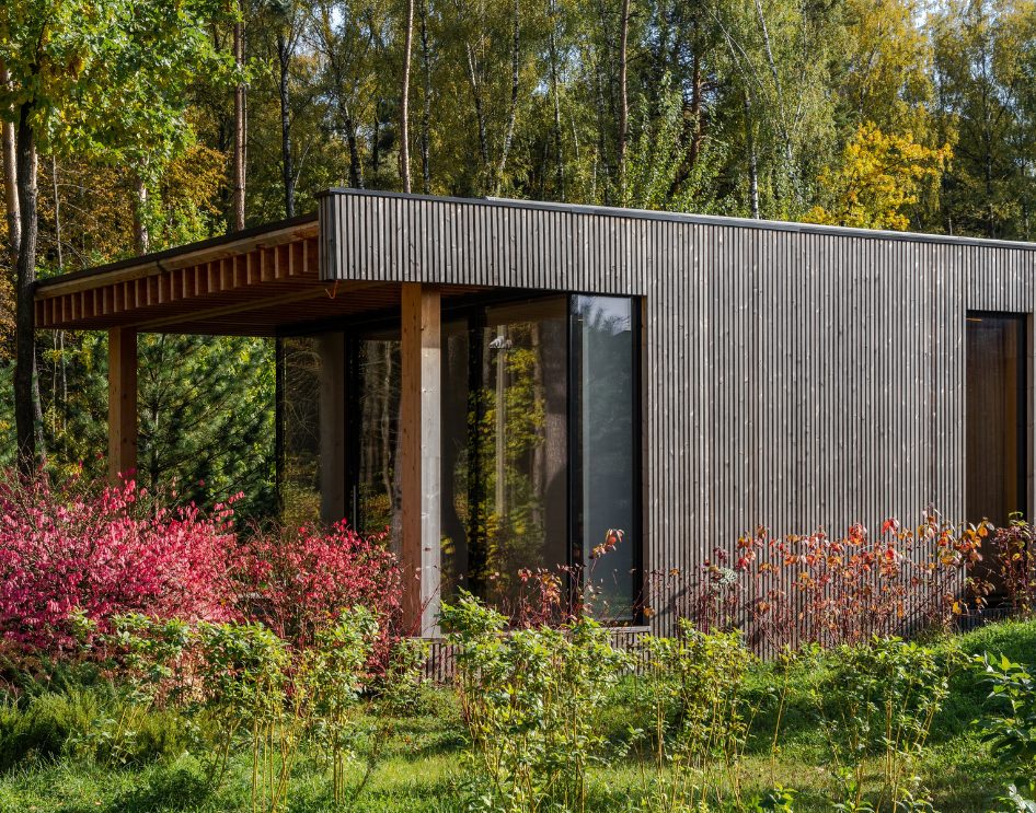 Manufactured ADUs - Timeline - Modern prefab ADU with black and wood exterior under blue skies.